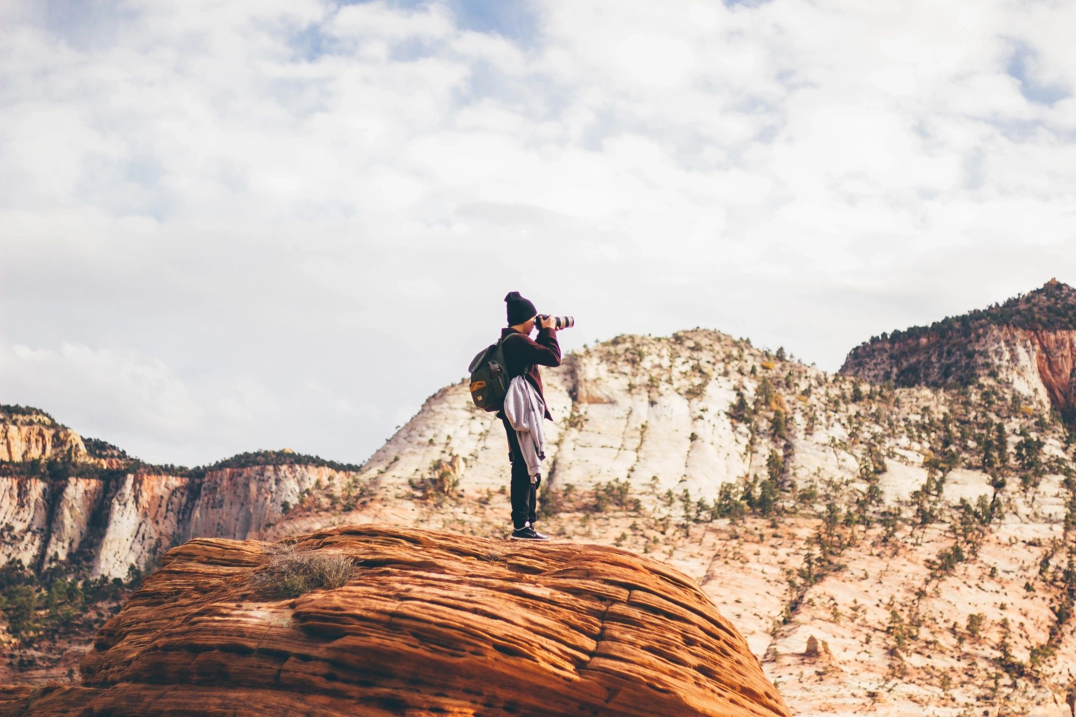 A person standing on top of a rock.